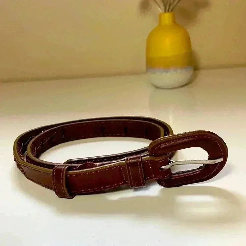 Source Unknown,brown braided leather belt with gold stitching